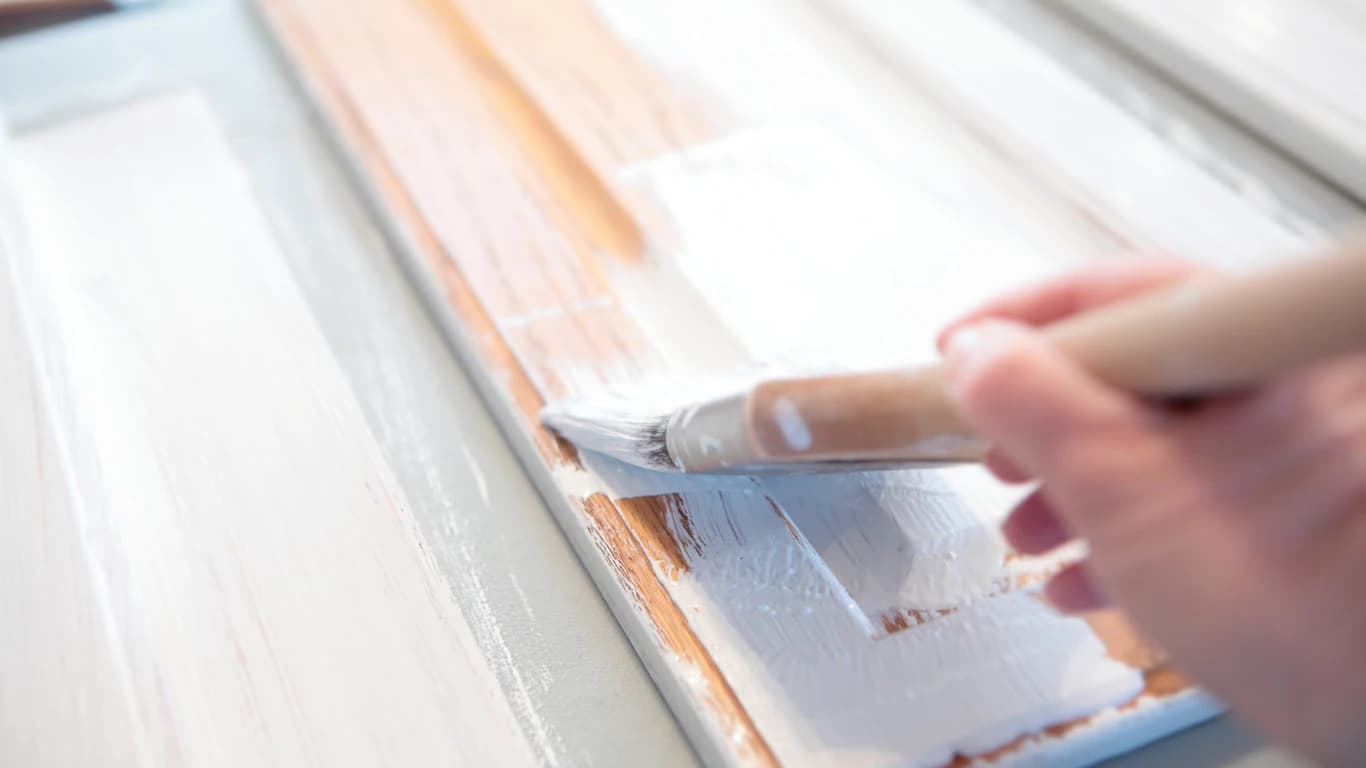 Applying high-adhesion primer to cabinets